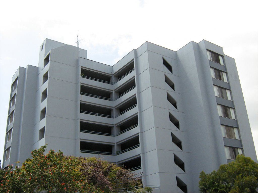 a large white building with trees in front of it